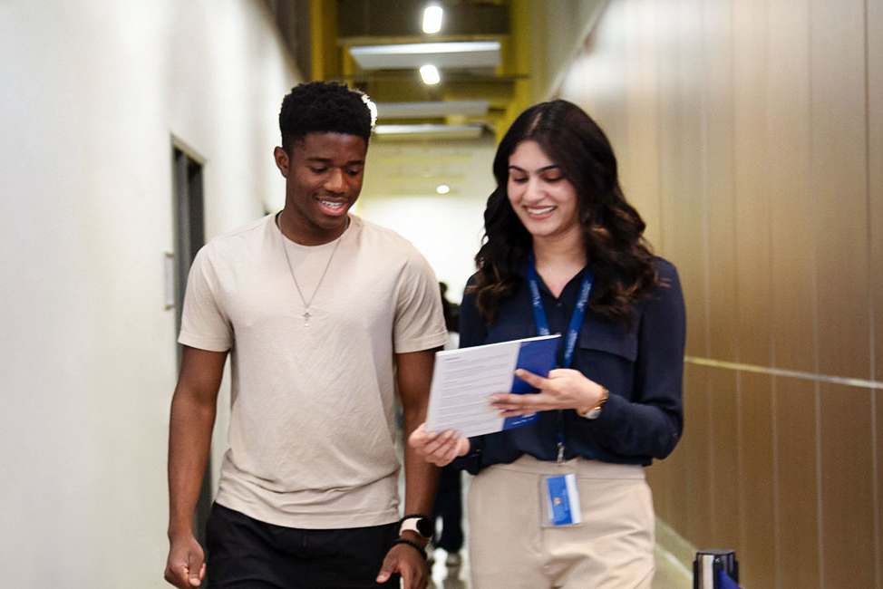 staff walking with a student