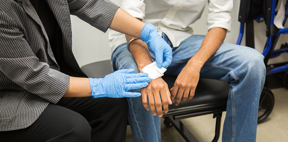staff providing first aid to students