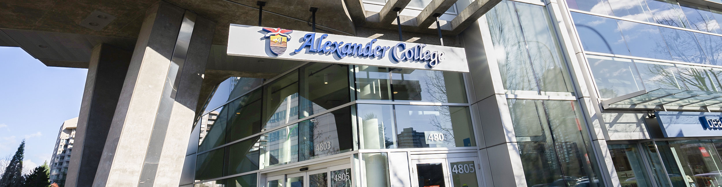 The Alexander College sign above the main entrance of Burnaby campus