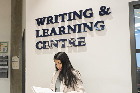 student outside the Writing and Learning Centre