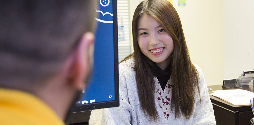Alexander College staff helping a student