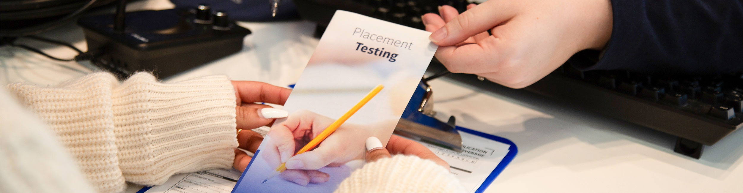 Student holding a Placement Testing borchure