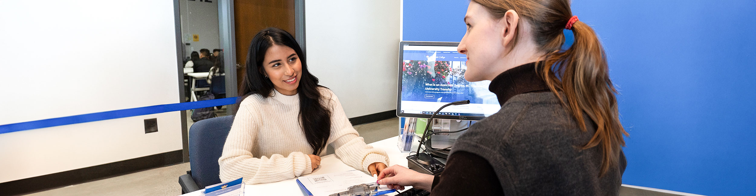 Alexander College staff helps a student