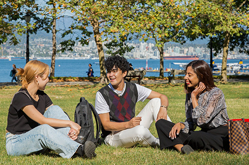 students studying in the grass