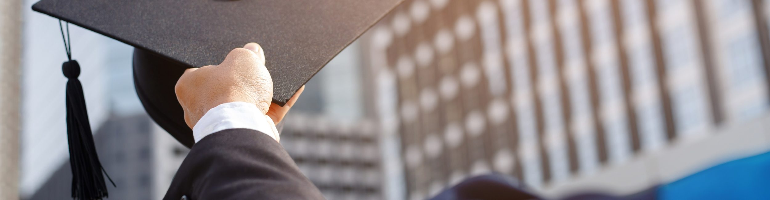 A person holding a graduation cap