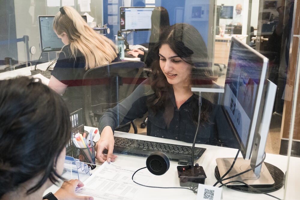 amanpreet helping a student at the front desk