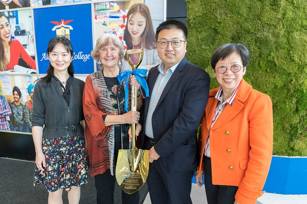 Eric and Barbara along with Burnaby hospital representative holding a commemorative Golden Shovel