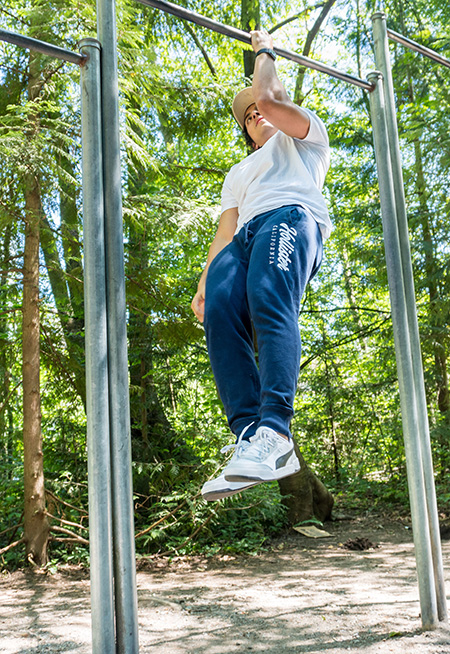 student lifting himself up on a pull-up bar