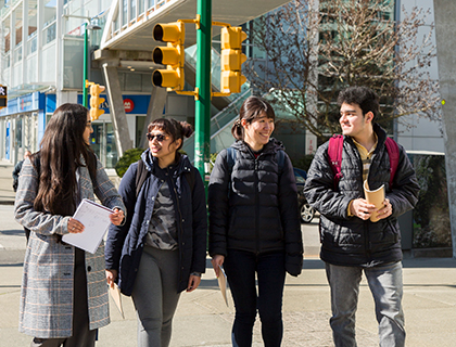 four students walking outside Alexander College Burnaby