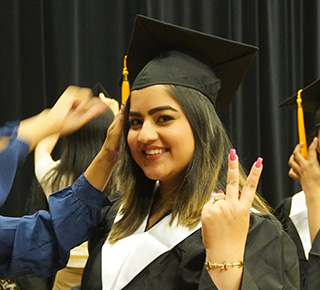 student posing for grad