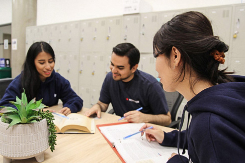 three students studying together