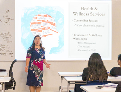 Muge giving a presentation on Health and Wellness services