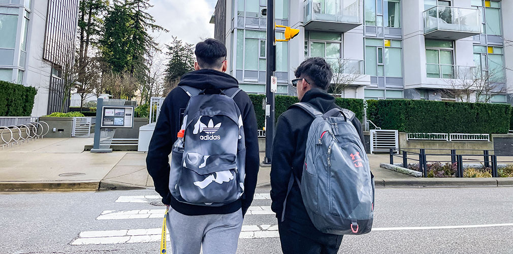 Herschelle walking with another student outside