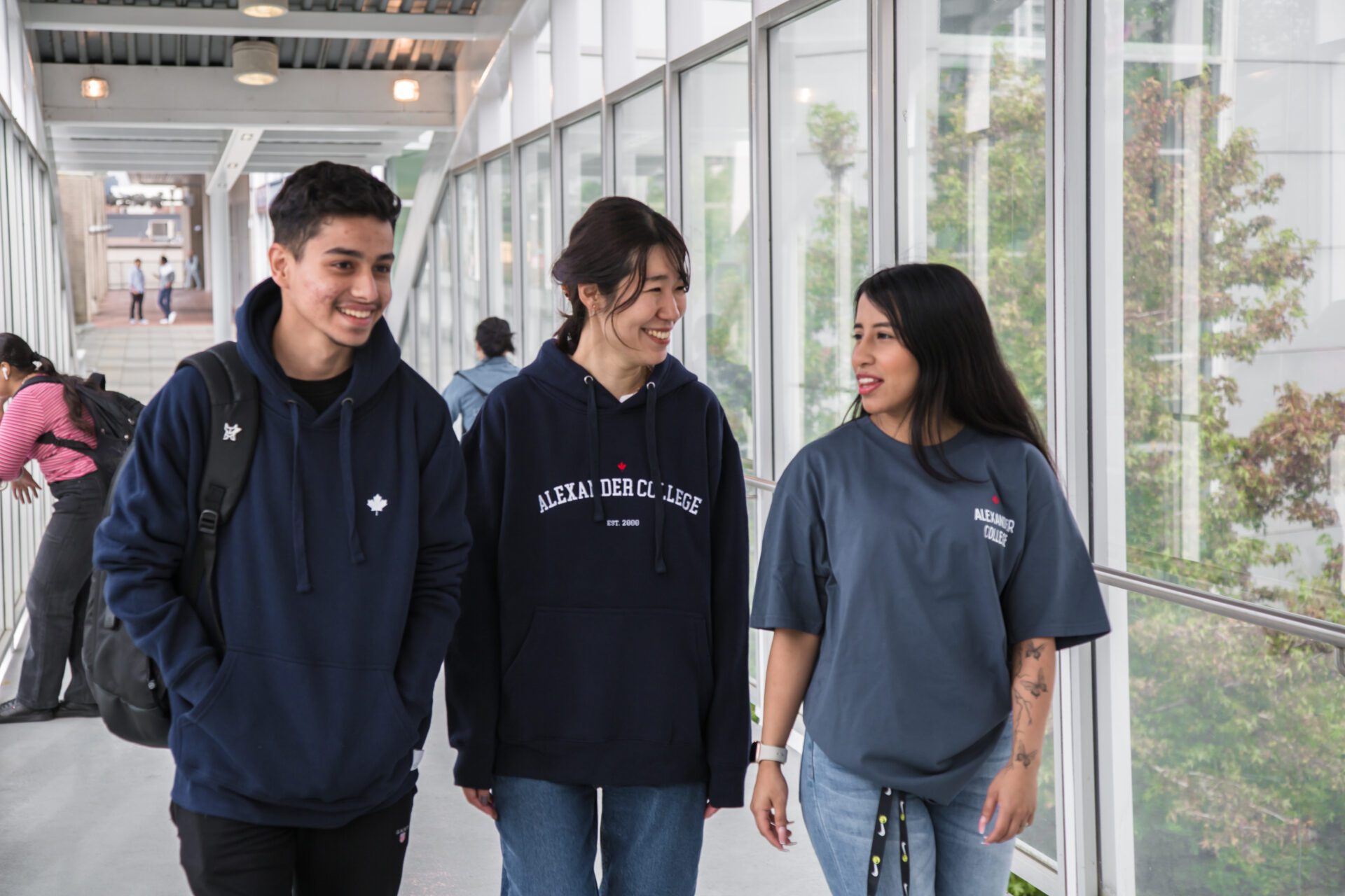 Group of students showing off AC apparel