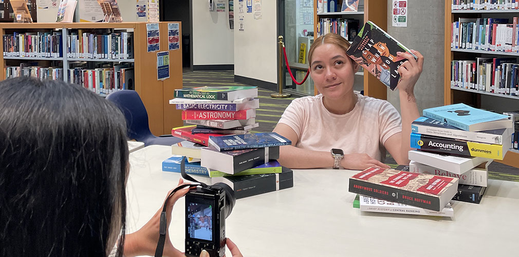 librarian holding up a book