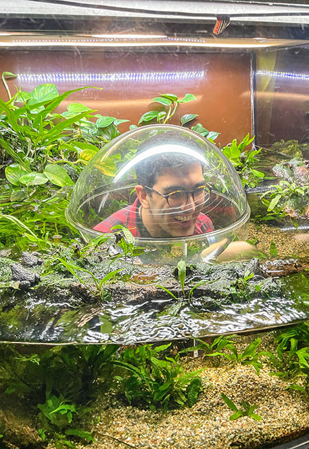 Gabriel looking at frogs