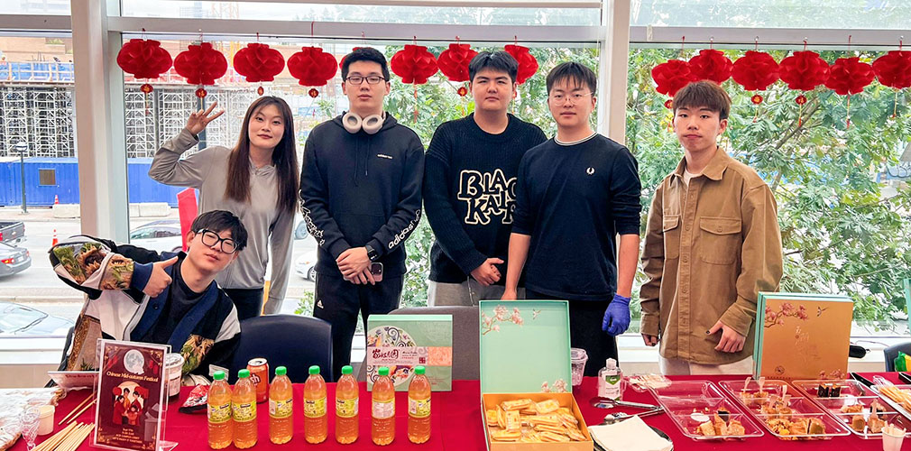 group photo with Mid-Autumn Festival table