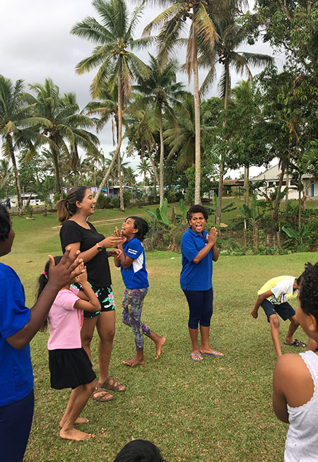 Rochelle laughing along with children