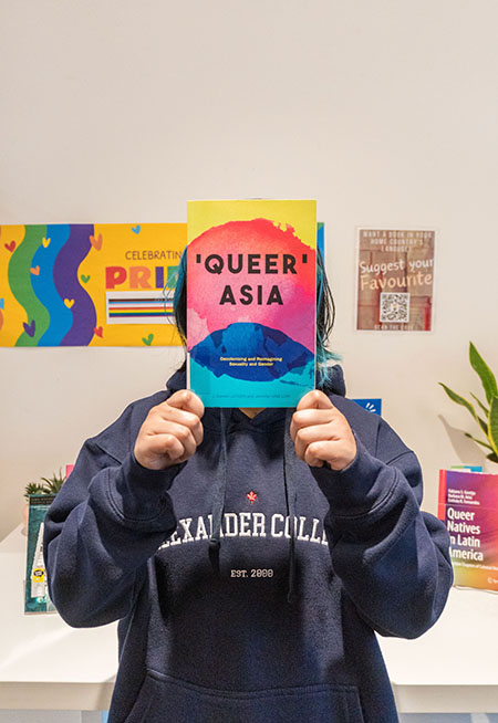 a student holding up a book