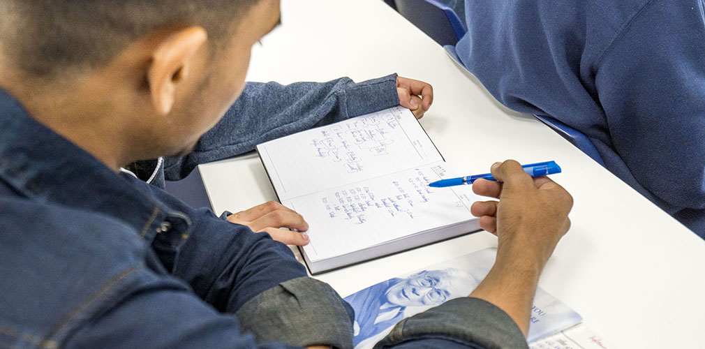 student reviewing notes in a classroom