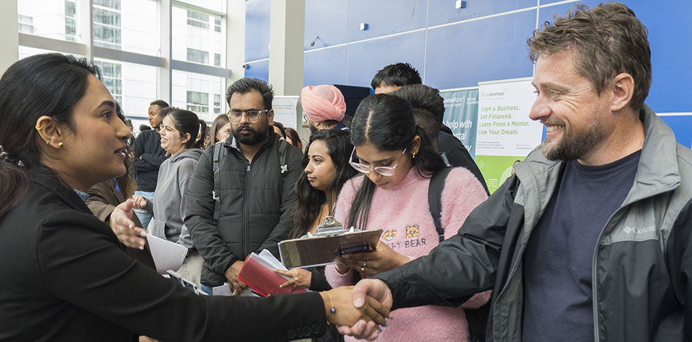 employer shaking hands with a student