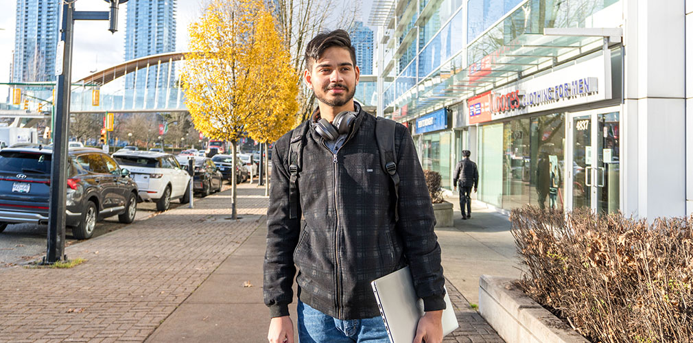 student looking off to the horizon outside campus