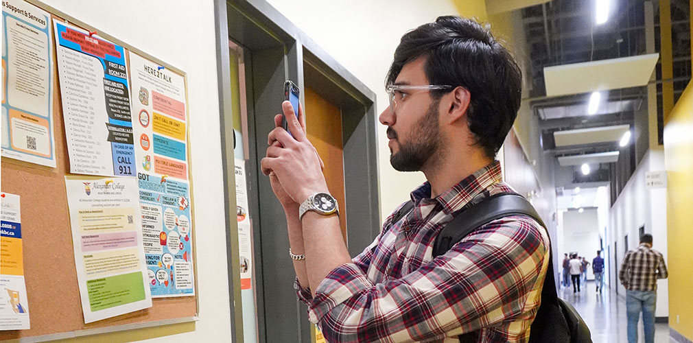 Vanshik taking a picture of the bulletin board