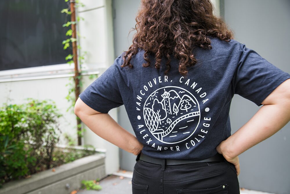 Student showing off back of tshirt