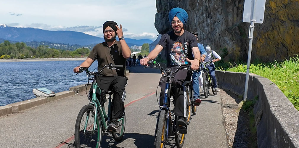 two students biking in Stanley Park