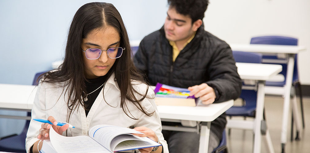 two students studying in a classroom