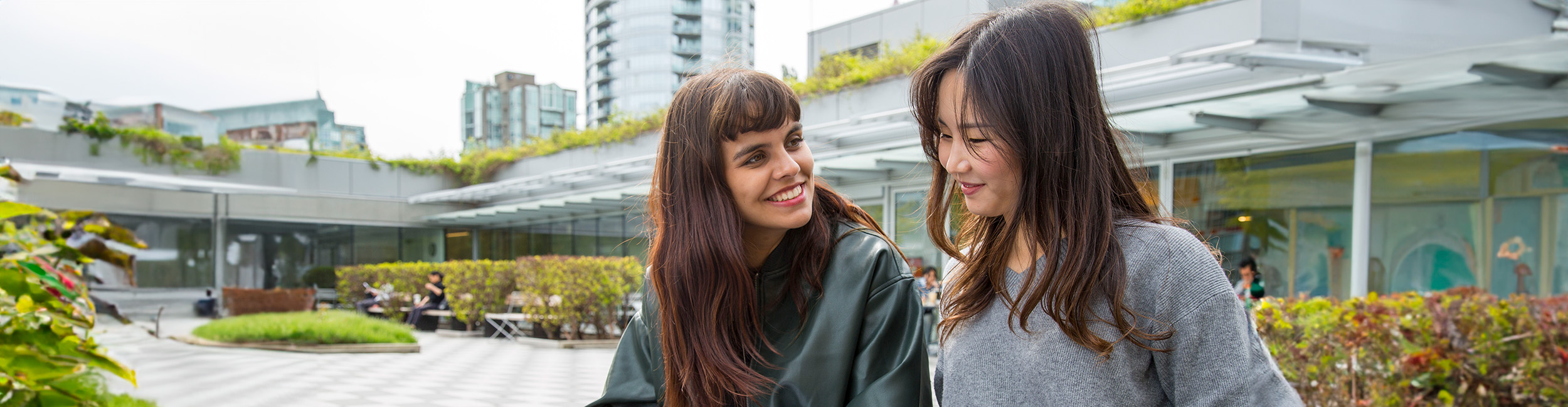 two students sitting outside