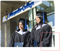 students in graduation regalia standing outside Alexander College